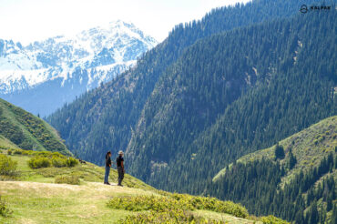 Kyrgyzstan mountains view observed by standing people
