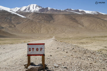 Pamir Highway stop road sign on empty way