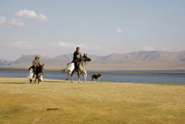 Central Asia tour locals riding at the lake